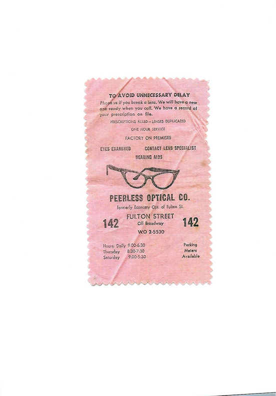 A pink Peerless Optical Co. lens cloth listing services including prescriptions filled and one-hour service.