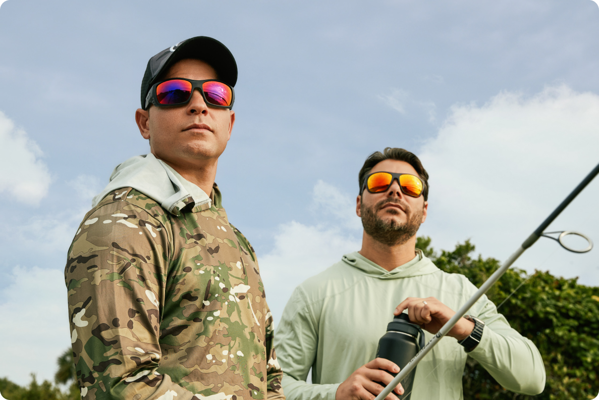 Two men wearing sunglasses fishing