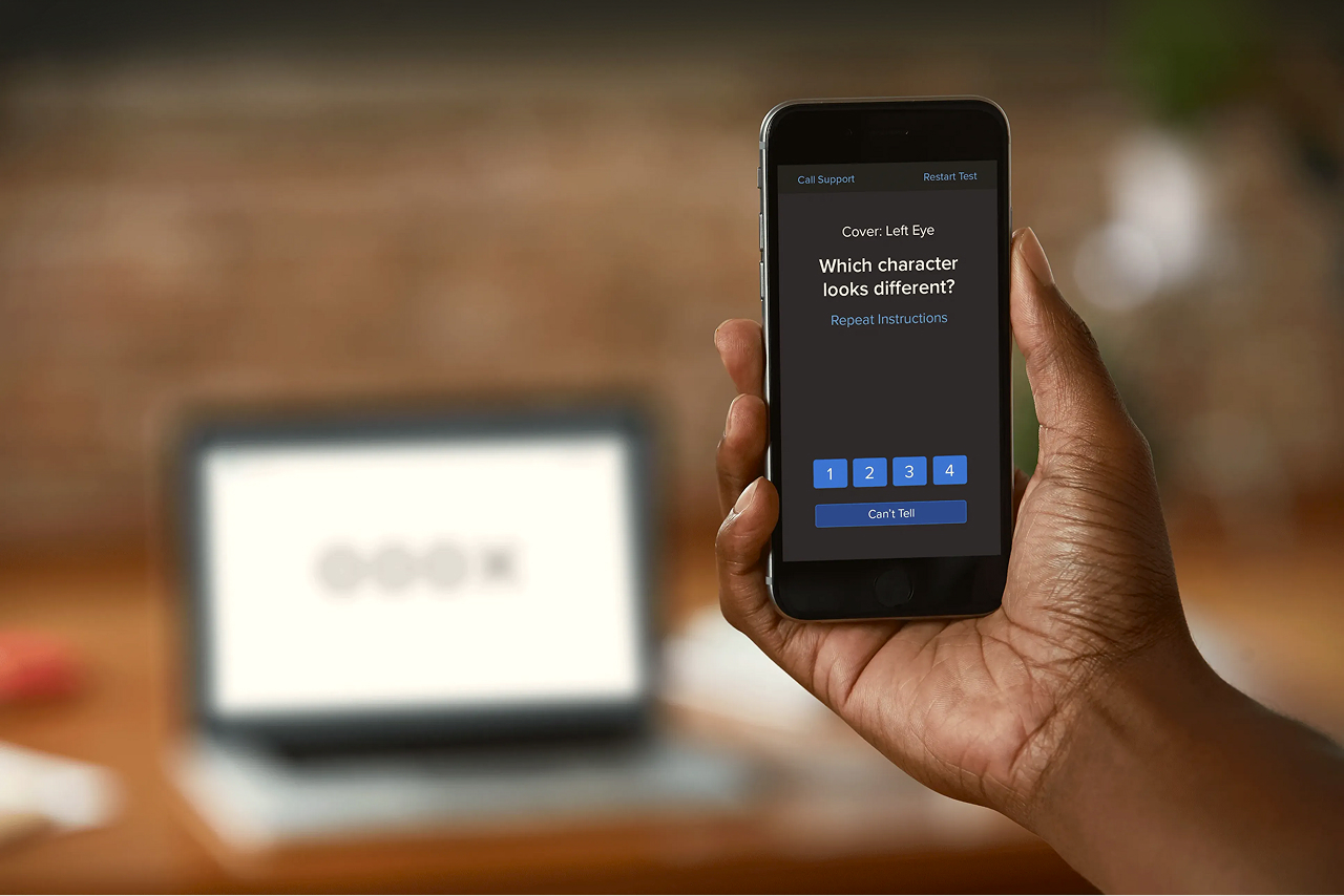 person holding phone taking online vision test