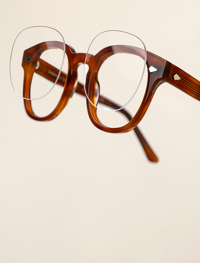 Glasses frames with lenses floating outside them.
