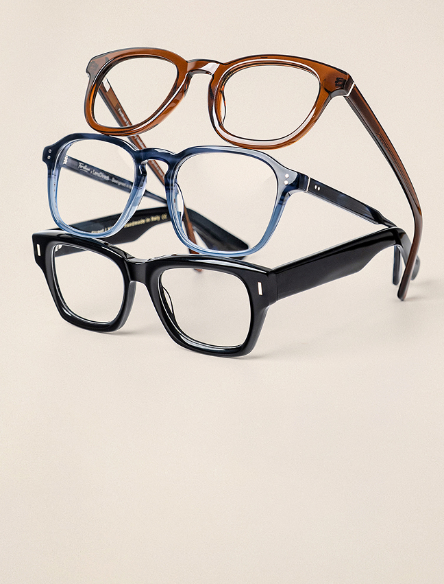 Glasses frames stacked on top of each other.