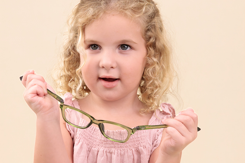 girl holding glasses while bending frames