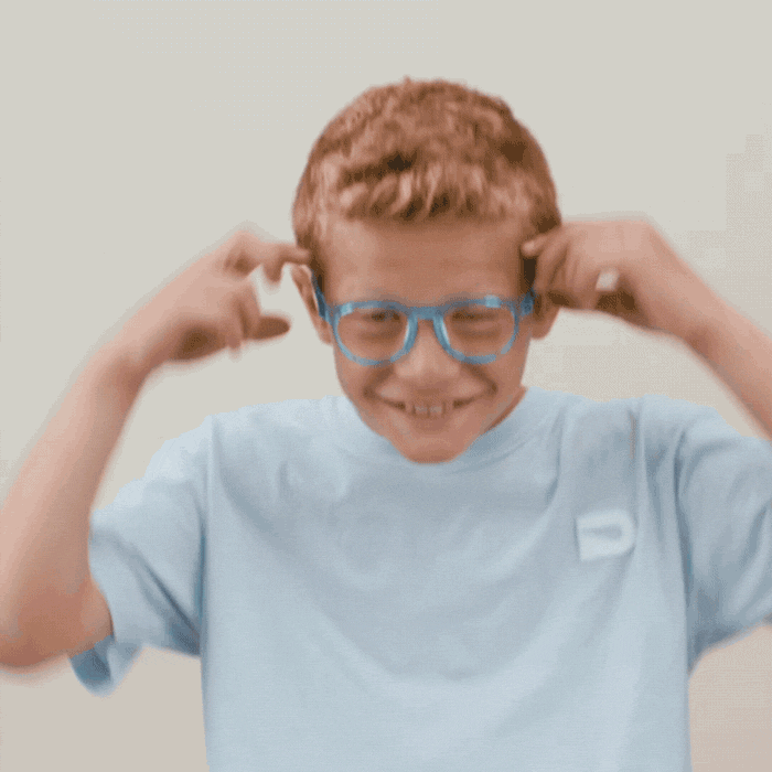 boy holding glasses while bending frames